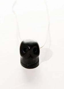 GOREY, Edward (1925 - 2000) Skull Necklace: GOREY, Edward (1925 - 2000) Skull NecklaceA skull neclace on a string, possible onyx, turquoise, or Abyssinian. Provenance: Edward Gorey to the Edward Gorey Charity Trust, Accompanied by a letter
