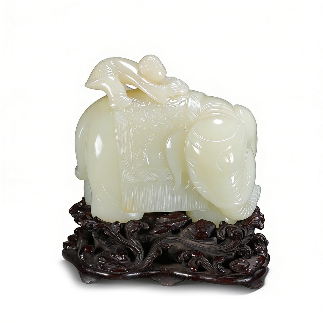 A Fine Chinese Pale Celadon Jade Carving of a Boy and Elephant, Qing Dynasty, Qianlong Period: L :9.2cm W :5cm H :8.2cm Weight :593.3g A fine Chinese pale celadon jade carving of a boy and elephant, Qing Dynasty, Qianlong period, depicting a playful boy atop a reclining elephant with a carved s