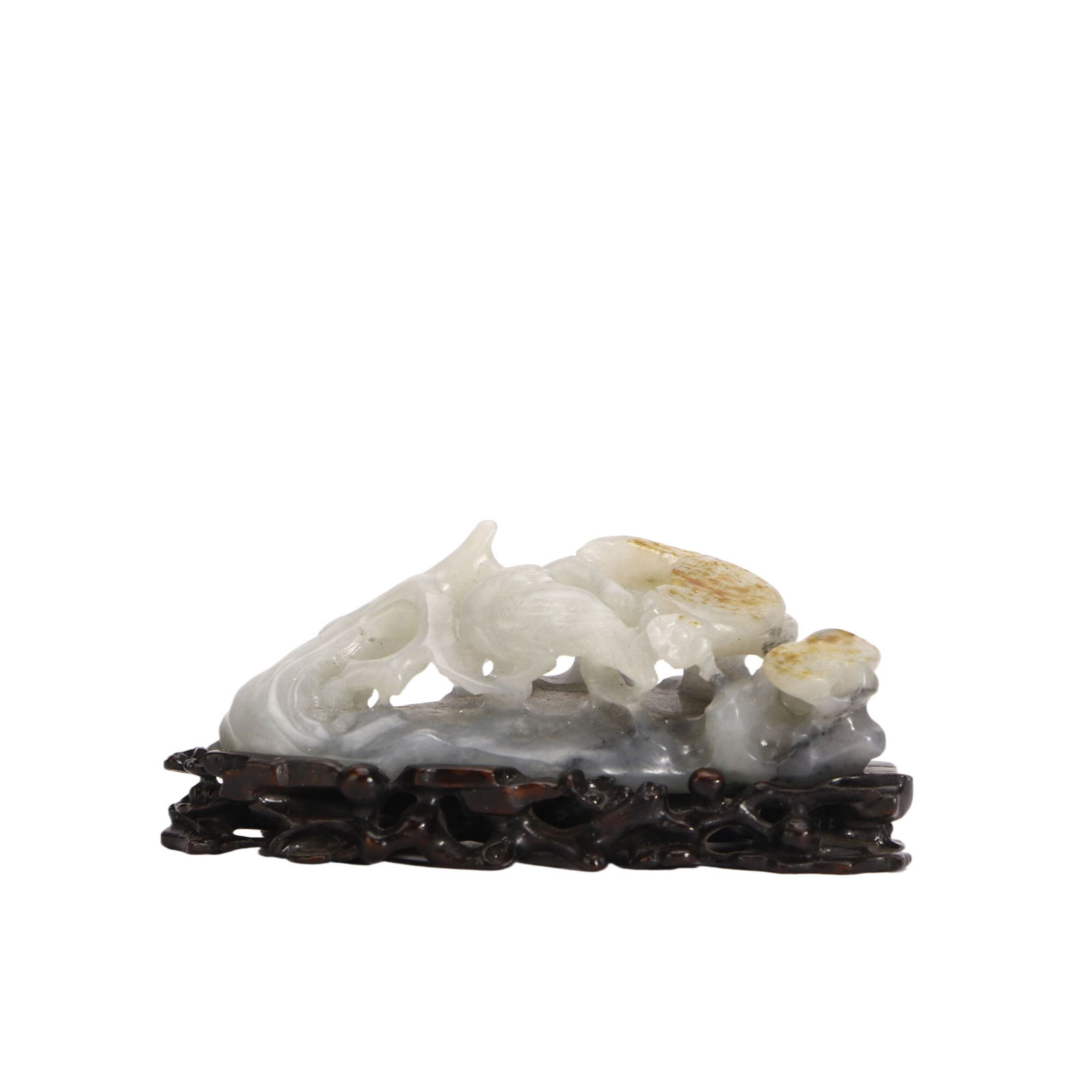 A Fine Qing Dynasty Jade ornament: L :8cm H :3.5cm This exquisite carving is masterfully crafted from a piece of black and white jade, utilising the natural colour variations to create a charming scene of a magpie perched on a blossomi