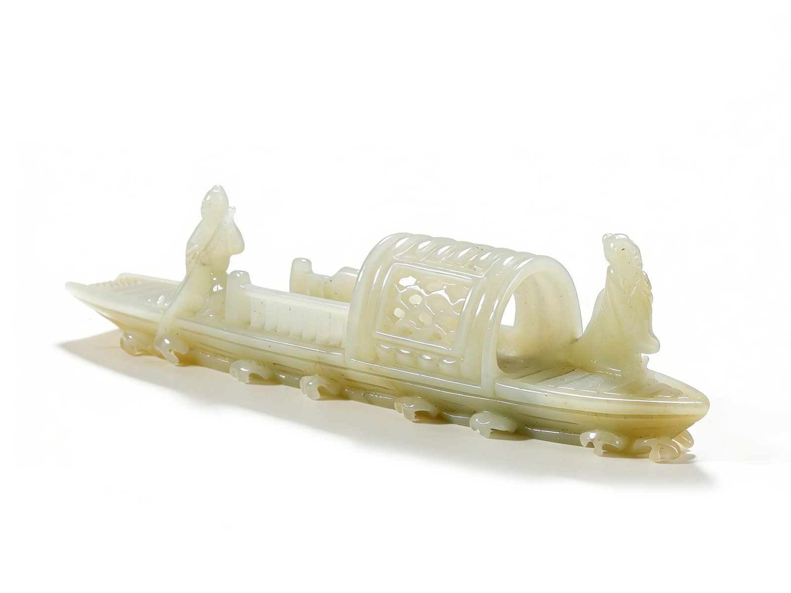 A QING DYNASTY HETIAN WHITE JADE CARVING OF A BOAT-SHAPED ORNAMENT WITH FIGURE STORY PATTERNS: H :3cm W :13cm This lot is a Qing Dynasty Hetian white jade carving of a boat-shaped ornament with figure story patterns, crafted from top-quality Hetian white jade with natural light sugar-coloured i