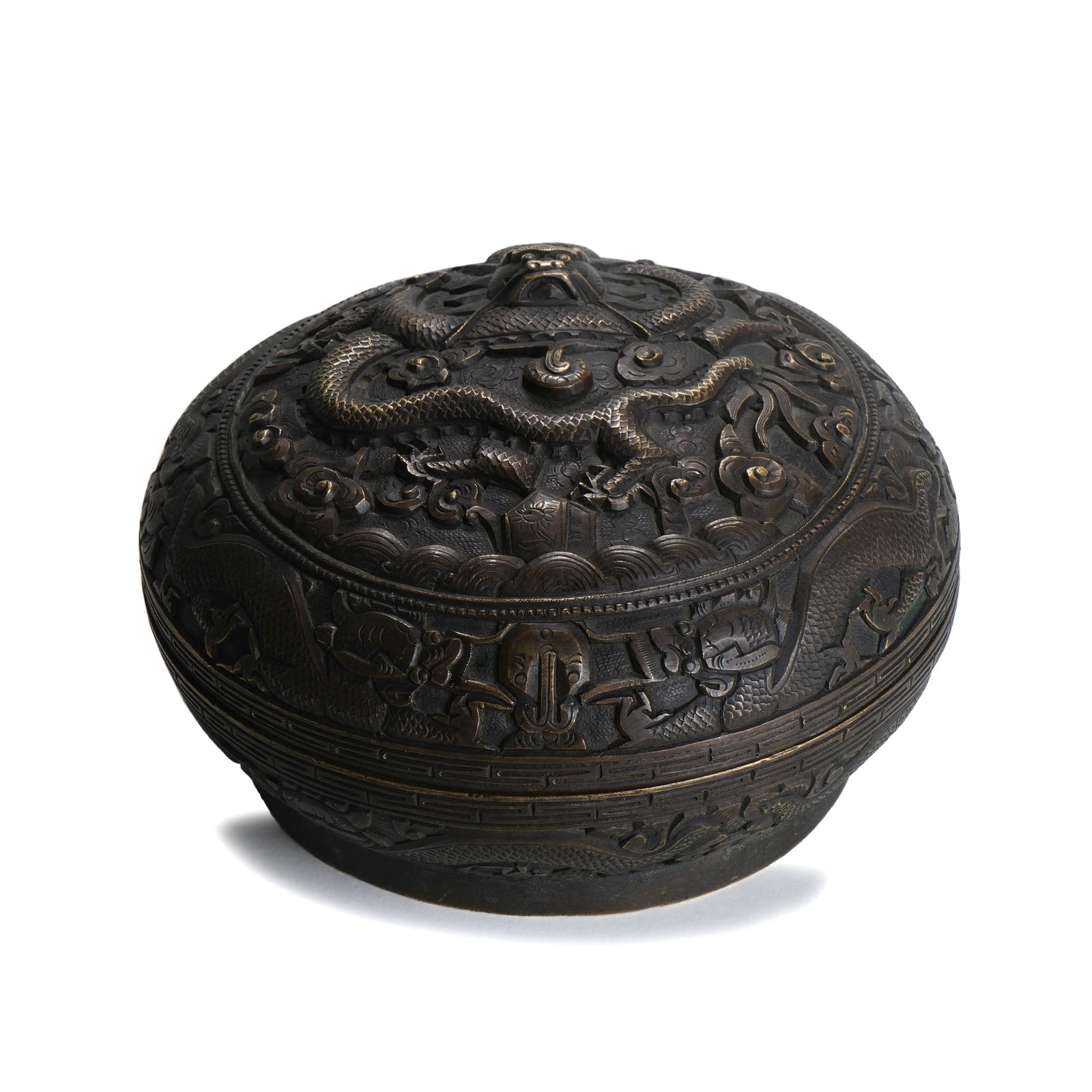 Qing Qianlong Bronze Box with High-Relief Dragon-and-Sea Pattern: H :9cm W :15.5cm This Qing Qianlong Bronze Box with High-Relief Dragon-and-Sea Pattern is a fine imperial bronze utensil of the Qianlong period. It takes the form of a flat round box, made of pure cop