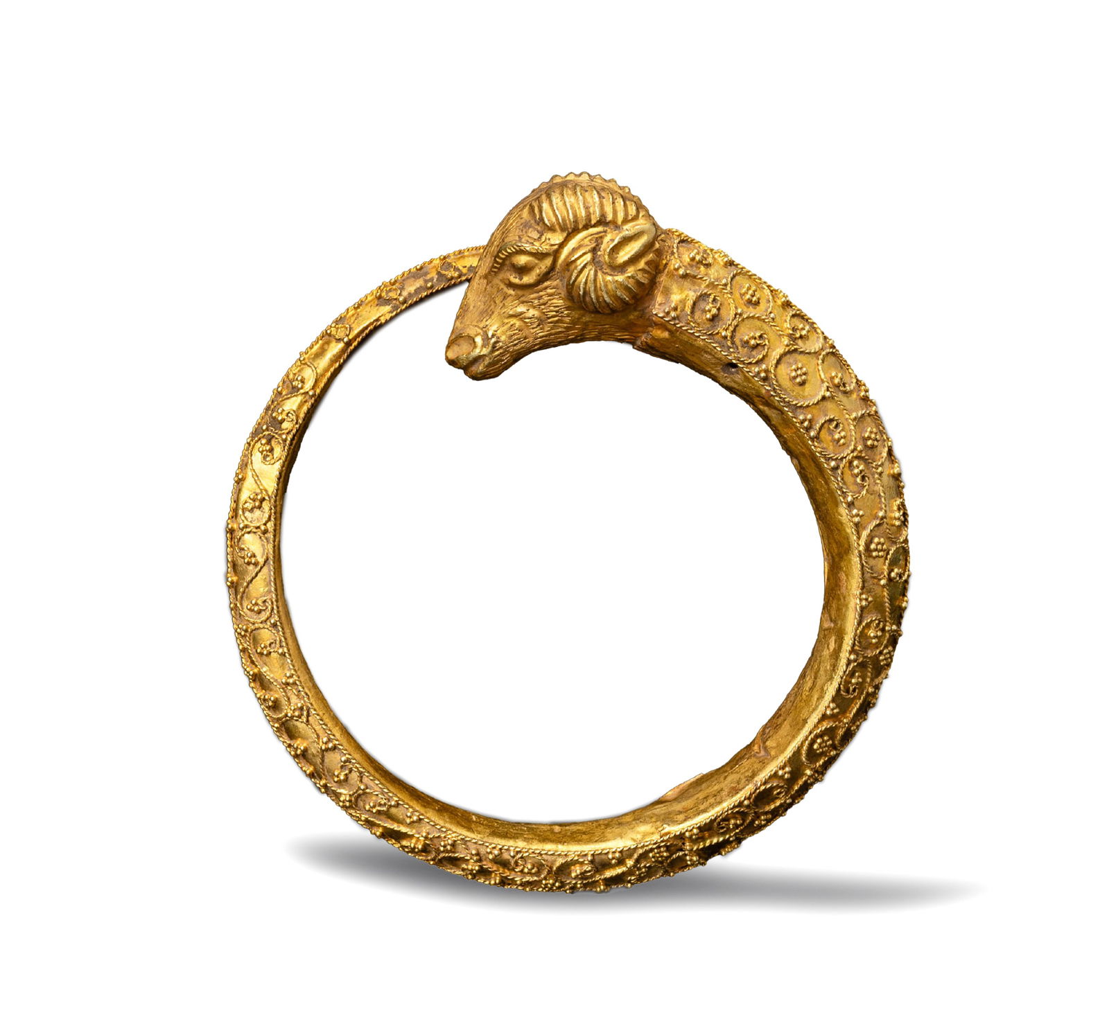 Ancient Hellenistic Bactrian 19K Gold Ram Head Cuff Bracelet: Elegant ancient Bactrian Hellenistic gold cuff bracelet, crafted in solid 19K gold (34g). Decorated with finely detailed ram head terminals and a graceful floral pattern.Material : 19K Gold Weight :