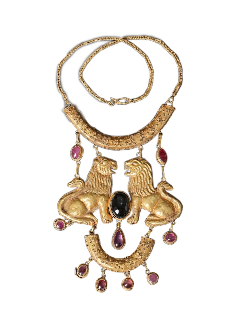Ancient Bactrian 17K Gold Necklace with Double Lion Motif and Rubellite Gemstones: Rare and striking Ancient Near Eastern Bactrian necklace crafted in 17K gold, weighing 66 grams. This exquisite piece features a bold double lions motif symbolizing power and protection, beautifully c