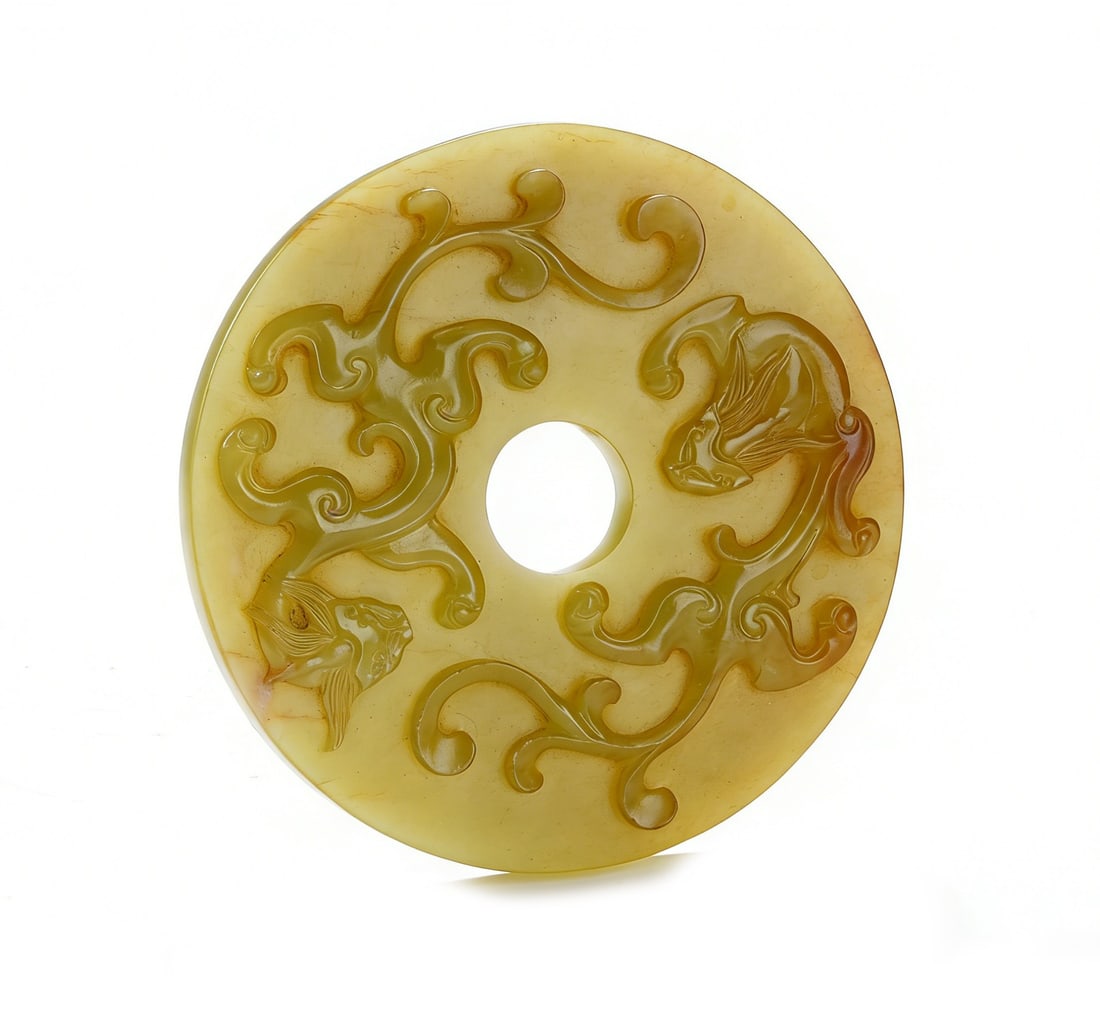 A QING DYNASTY YELLOW JADE BI DISC CARVED WITH TWO CHILONG PATTERNS: H :1cm W :7cm This lot is a Qing Dynasty yellow jade bi disc carved with two chilong patterns, crafted from top-quality Hetian yellow jade with a warm beeswax-yellow colour and natural reddish-brown i
