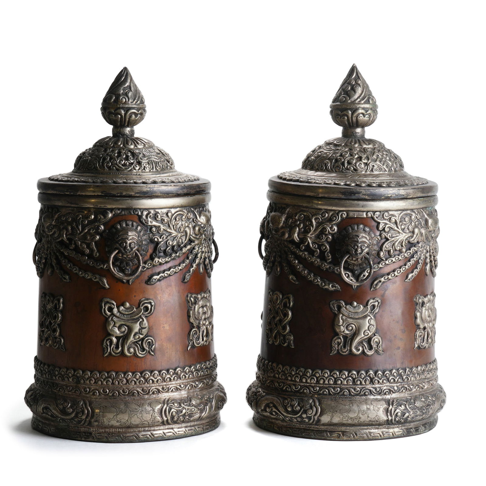 Qing Dynasty Pair of Silver-Plated Bronze Jars with Eight Auspicious Symbols and Lion Handles: H :30cm W :15.5cm This pair of Qing Dynasty Silver-Plated Bronze Jars with Eight Auspicious Symbols and Lion Handles is a fine Qing copper utensil in Tibetan Buddhist style, and its preservation in a