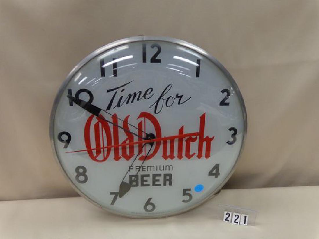 OLD DUTCH PREMIUM BEER ELECTRIC WALL CLOCK ILLUMINATED: CLOCK ILLUMINATED & RUNNING, 15 IN. X 4 IN. - TWO REAR ACCESS PANELS MISSING & ALUMINUM HANGING BRACKET ADDED - INTERIOR GLASS PANEL IS CRACKED