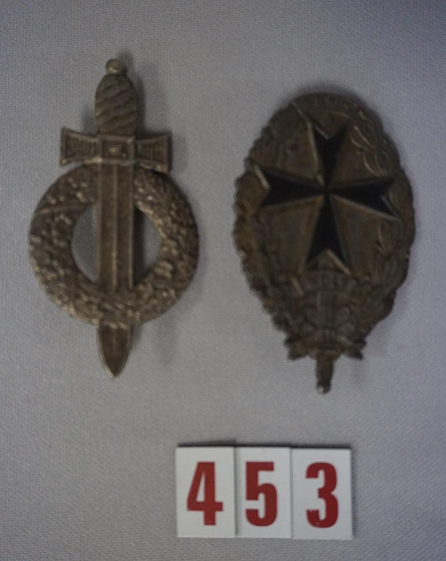 (2 PIECES) FREIKORPS BADGES:: FREIKORPS WOLF OVAL WREATH WITH BLACK CROSS & SWORD WITH WOLF & WITH PINBACK, SOME RUST ON BACK OF BADGE - FAIR & BADGE WITH AN OAK WREATH & SWORD WITH PINBACK - GOOD