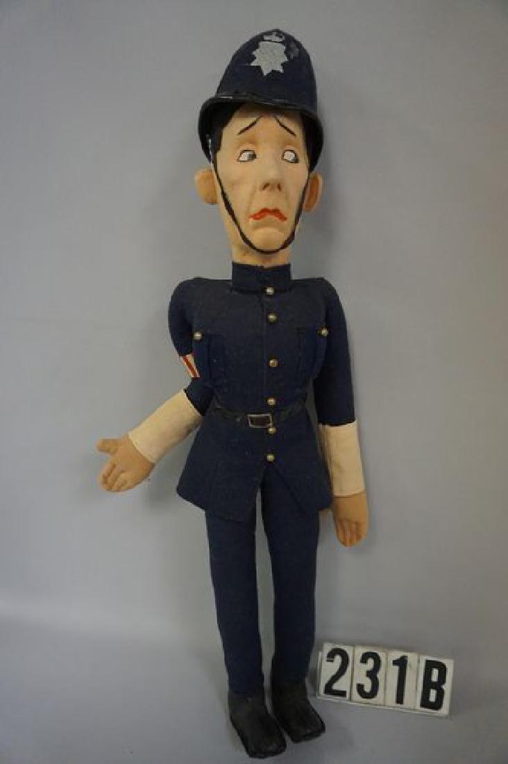 STAN LAUREL 19 INCH CLOTH & FELT: CHARACTER DOLL BY RICHARDS SON & ALLWIN LTD. OF GREAT BRITAIN, ALL ORIGINAL & DRESSED AS AN ENGLISH 'BOBBY' (POLICEMAN) WITH HAT, PAINTED FACIAL FEATURES WITH A PENSIVE LOOK ON HIS FACE, SMALL AREA WI