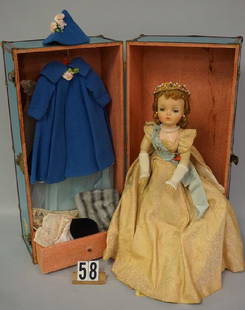 MADAME ALEXANDER 20 INCH (1957) CISSY: QUEEN WITH ROYAL TROUSSEAU IN FAO SCHWARTZ METAL TRUNK WITH TRAVEL DECALS, 24 IN. H, 12 IN. W, 11 1/2 IN. D - GOOD, WARDROBE INCLUDES #2170 BRIDE GOWN, BALL GOWN, LACE NEGLIGEE, COAT & HAT & MORE - GO