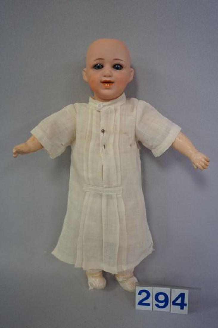 GEBRUDER HEUBACH 5636 11 INCH CHARACTER: FACE BOY (NEEDS A WIG), SOCKET HEAD WITH SUNBURST MARK, BLUE GLASS SLEEP EYES, LAUGHING, OPEN MOUTH WITH TWO MOLDED & PAINTED BOTTOM TEETH, JOINTED WOODEN BODY WITH ORIGINAL FINISH & MINOR WEAR IN ARE