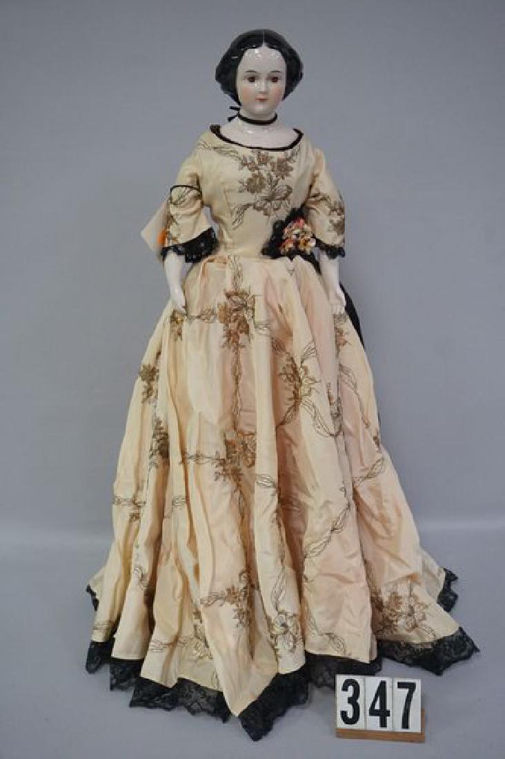 EMMA CLEAR 23 INCH CHINA HEAD (UNSIGNED): JENNY LIND' WITH EARLY STYLE S-PLATE, BROWN EYES, BRUSH STROKED HAIR, EARLY STYLE HIGH BROW HAIR WITH MOLDED BUN ON BACK SIDE, CHINA LIMBS, MOLDED & PAINTED COPPER LUSTER BOOTS, WELL DRESSED IN PERIOD