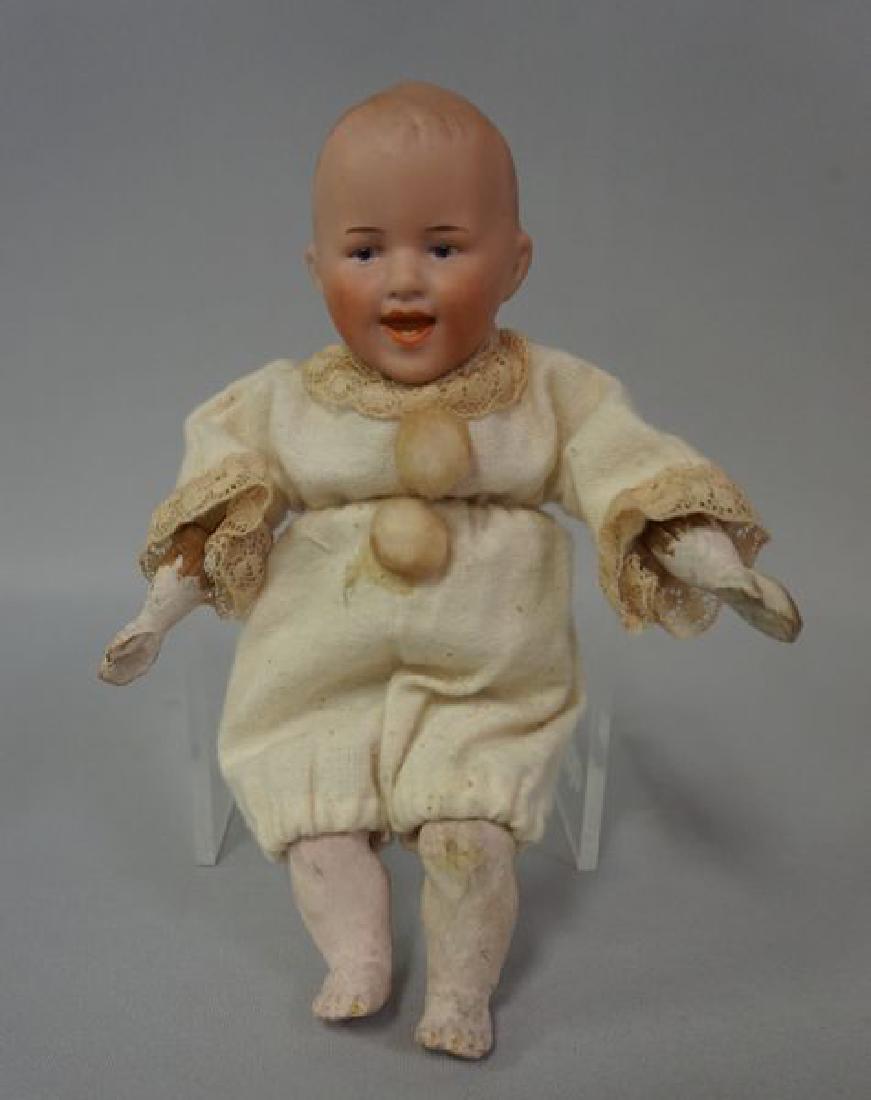 HEUBACH 6736 7 1/2 INCH BISQUE HEAD: CLAPPER' BABY, VINTAGE CHEMISE OUTFIT, BISQUE HEAD WITH MOLDED & PAINTED HAIR, OPEN MOUTH WITH TWO BOTTOM TEETH, SQUEEZE BOX IN TORSO CREATES CLAPPING MOTION - WORKING ORDER, CARVED WOODEN ARMS & HAND