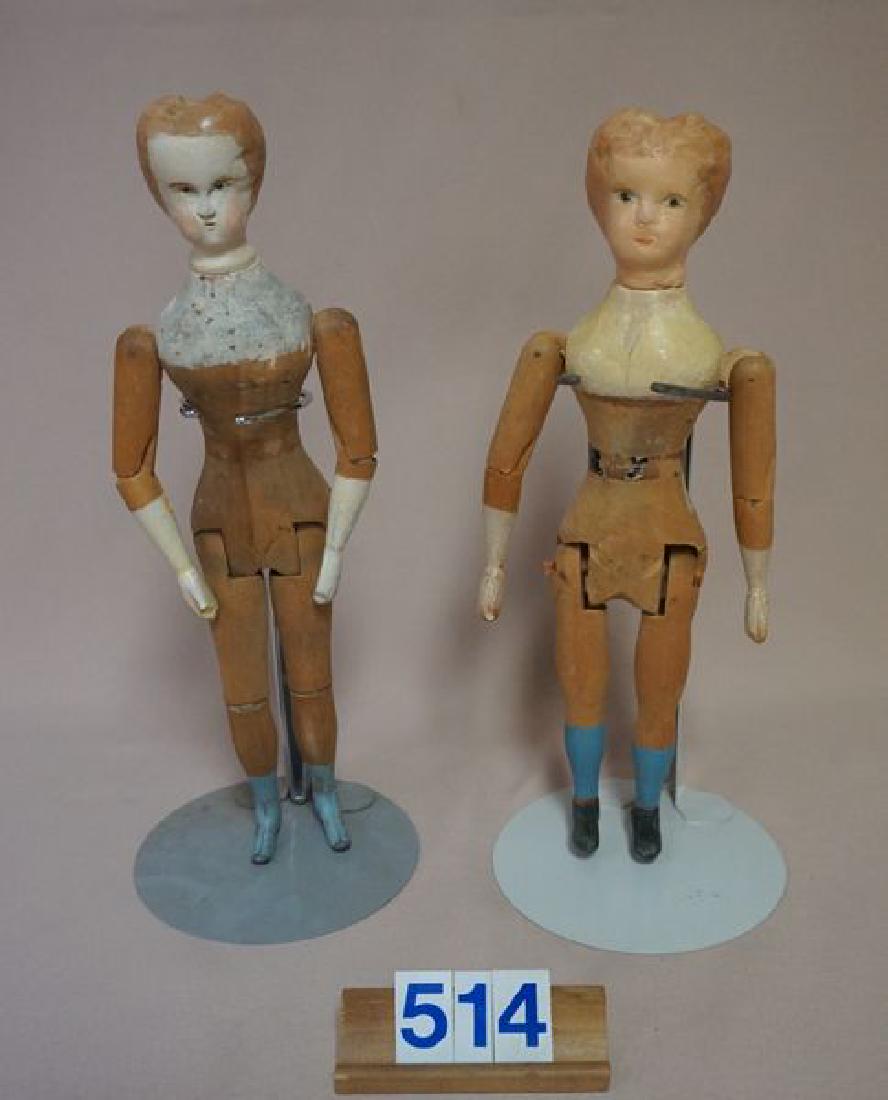 (2 PIECES) VERMONT WOOD 11 1/2 INCH & 10 3/4 INCH: WOODEN DOLLS BY MASON & TAYLOR, EACH WITH REPAINTED / TOUCHED-UP AREAS ON HEADS & BLOUSES, LARGER DOLL WITH METAL SHOES - EARLY AMERICAN JOINTED WOODEN DOLLS - POOR TO FAIR