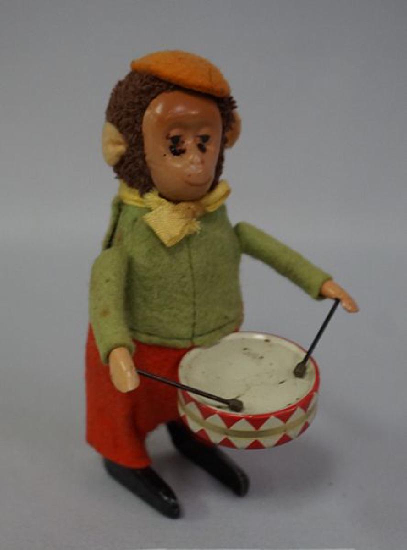 SCHUCO MONKEY WIND-UP WITH DRUMSTICKS: 4 1/2 IN. H, PLAYS TIN DRUM WHEN WOUND, NO KEY, WORKING - GOOD