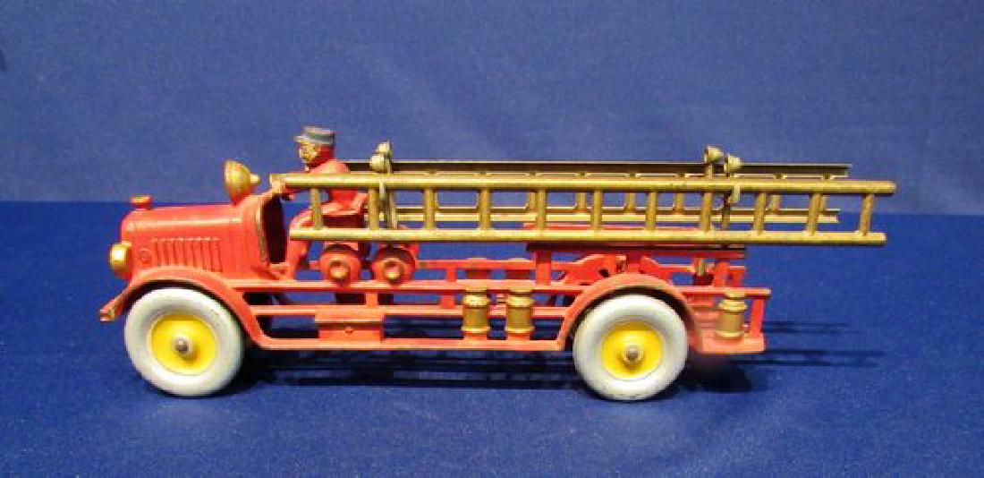14 IN. CAST IRON FIRE TRUCK:: UNMARKED, POSSIBLY ARCADE, ALL METAL, FIRE TRUCK COMPLETE WITH SEARCH LIGHT & (2) LADDERS - MINOR PAINT LOSS