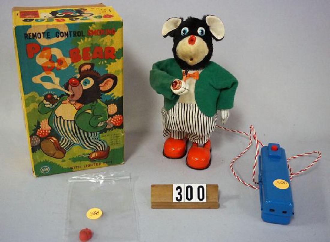 MARUSAN TOYS REMOTE CONTROL SMOKING: PAPA BEAR, 9 IN. BATTERY OPERATED BEAR WITH TIN LITHO PIPE IN EXCELLENT WORKING ORDER, BEAR MOVES FORWARD AS PIPE MOVES TO MOUTH & LIGHTS UP, BEAR CONTINUES TO MOVE FORWARD AS ARM WITH PIPE MOVES DOWN