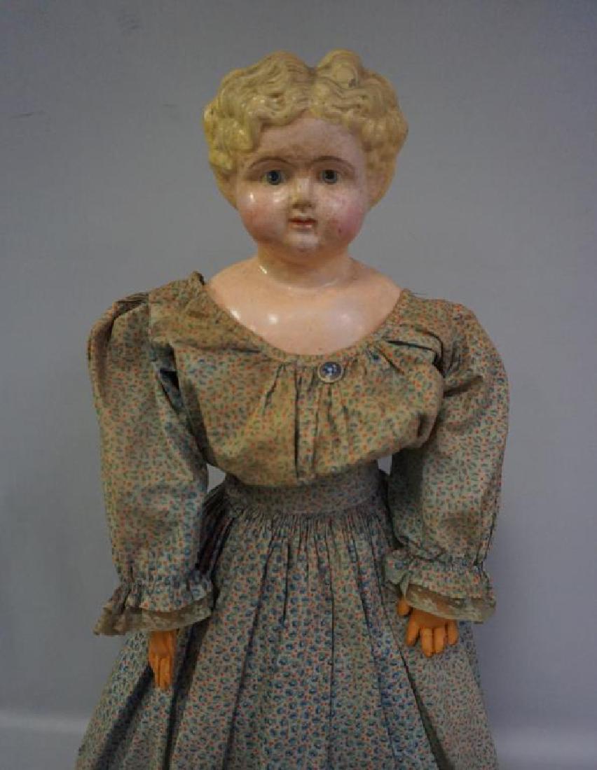 24 INCH PAPIER MACHE SHOULDER HEAD DOLL WITH BLONDE: 24 INCH PAPIER MACHE SHOULDER HEAD DOLL WITH BLONDE MOLDED HAIR, CLOTH BODY WAS REPLACED AS WERE HER LEATHER FOREARMS WITH HANDS, LOWER LEGS ARE VINTAGE INCLUDG. THE SEWN-ON BLACK BOOTS, SEVERAL SMALL