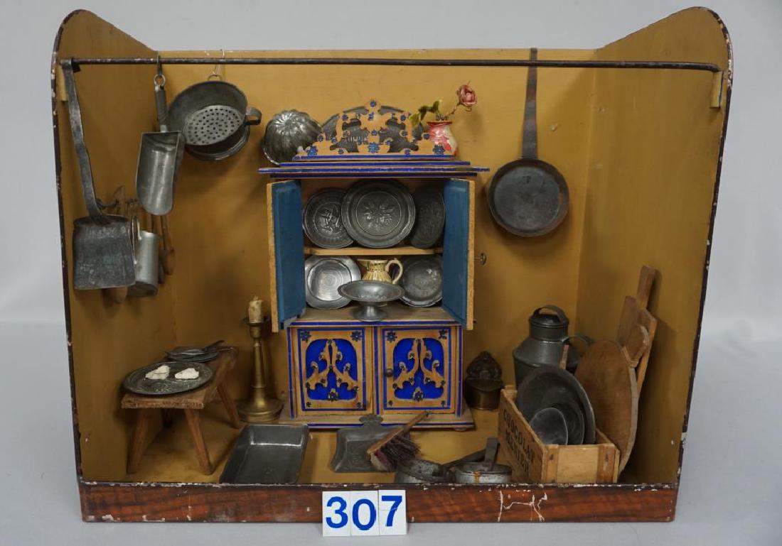 GERMAN PAINTED TIN CHOCOLATE SHOP KITCHEN DIORAMA,: GERMAN PAINTED TIN CHOCOLATE SHOP KITCHEN DIORAMA, CONTENTS INCLUDE DECORATED WOODEN TWO-DOOR CUPBOARD (GLASS DAMAGED ON LEFT DOOR), 12 IN. H, 7 IN. W, 3 IN. D, LOTS OF ASSTD. TIN POTS, PANS, MOLDS, E