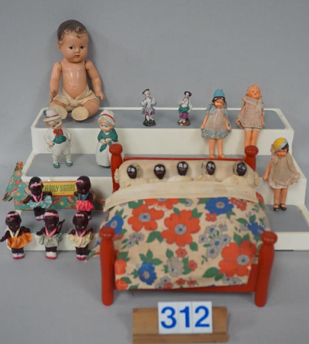 M. ALEXANDER 6 1/2 IN COMPO DIONNE QUINT - FAIR +, PR.: M. ALEXANDER 6 1/2 IN COMPO DIONNE QUINT - FAIR +, PR. OF 3 IN. BISQUE LMOTTERS - GOOD, (3) PAINTED BISQUE DOLL HOUSE DOLLS - GOOD, (5) 2 1/4 IN. BLACK CELLULOID YOUNG GIRLS, EACH WITH PINK BOW IN THE