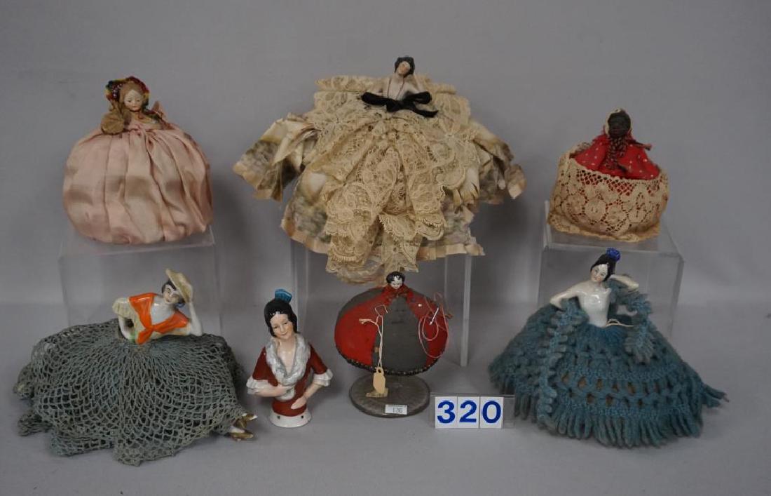 (6) CHINA/BISQUE HALF DOLLS, WITH PINCUSHION BASES,: (6) CHINA/BISQUE HALF DOLLS, WITH PINCUSHION BASES, MOST ARE GERMAN, 4 1/2 IN. TO 6 IN. H, HAVE BEEN DISPLAYED FOR MANY YEARS, FIGURINES & FABRICS SHOULD BE CLEANED, SMALL CHINA HEAD & BLACK MAMMY MAY