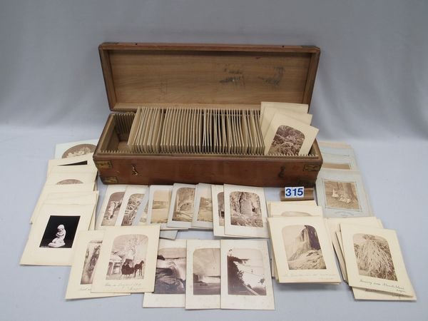 APPROXIMATELY 150 NIAGARA FALLS PHOTOS:: LARGE WOODEN BOX HOLDS CABINET CARDS OF LATE 19TH CENTURY IMAGES OF NIAGARA FALLS, DOGS, STATUARY, & WINTER SCENES. VAST MAJORITY ARE OF NIAGARA FALLS, INCLUDING A TIGHTROPE WALKER NEAR THE FALLS AND 