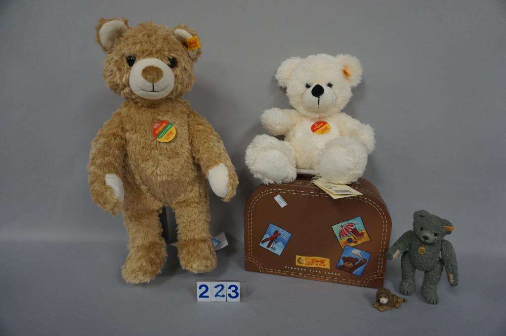 STEIFF 11 IN. ORIGINAL BEAR (WHITE): WITH ALL I.D. PIECES IN STEIFF TRAVEL SUITCASE, 1998 5 IN. PAINTED & JOINTED BISQUE TEDDY BEAR & 2 IN. LONG PAINTED METAL LION - ALL EX/MT+