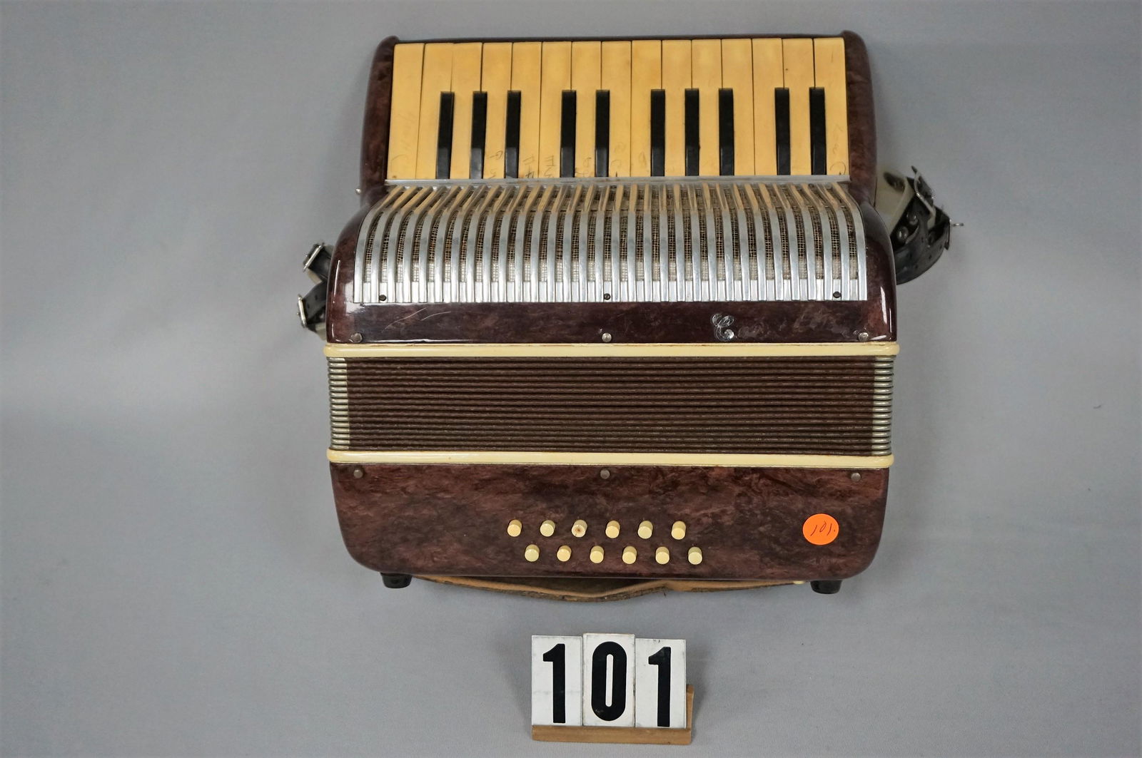 VINTAGE ACCORDION (MADE IN ITALY),: NAMEPLATE IS VIRTUALLY MISSING AS ONLY THE 'C' REMAINS, APPEARS THE NAME OF THE MANUFACTURER MAY BE CORELLI, CASE & BELLOWS ARE IN VERY GOOD WORKING CONDITION. KEYS HAVE INK NOTATIONS ON THEM, 14 IN.