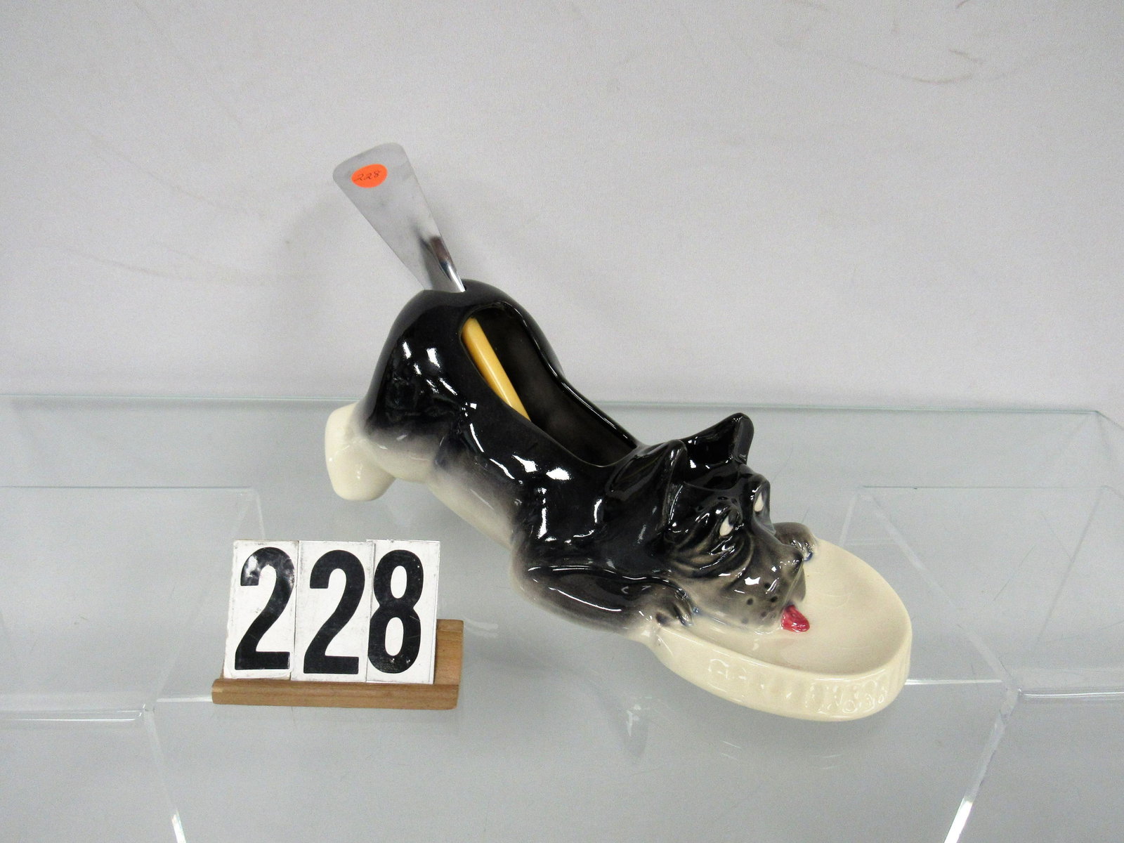 NELSON McCOY DOG WITH SPOON TAIL CADDY:: 10 IN. WITHOUT SHOE HORN. AVERAGE CONDITION