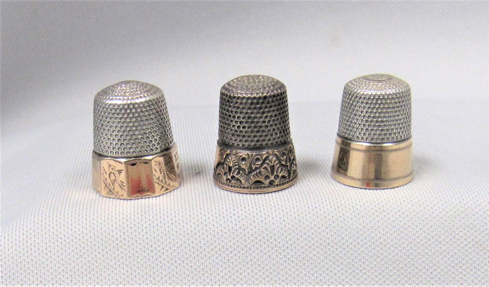 (3) SILVER THIMBLES WITH 14K GOLD BANDS:: 2 ARE MARKED STERLING, 1 IS UNMARKED - G/VG