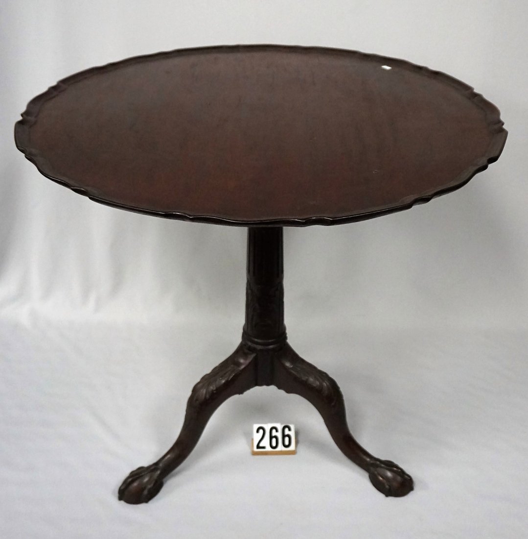 ANTIQUE MAHOGANY TABLE WITH BIRD CAGE,: PIECRUST EDGE TOP, CARVED PEDESTAL & LEGS, CARVED BALL & TALON FEET, ONE WITH EDGE MISSING, ONE LEG WAS DAMAGED (A LONG TIME AGO) & REINFORCED - SEE PHOTO(S), 29 1/2 IN. H WHEN TABLE TOP IS IN SET POS