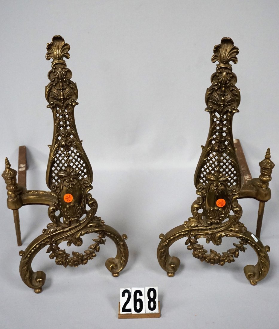 PAIR OF ORNATE SOLID BRASS ANDIRONS,: WITH EMBOSSED FLORAL & BASKETWEAVE DESIGN, EACH 22 IN. H, 9 1/2 IN. 24 1/2 IN. D INCLUDING THE CAST IRON LOG HOLDER - USED, NICE PATINA, NO DAMAGE - VG