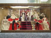 DISPLAY CASE OF 12 LIBERTY OF LONDON DOLLS: