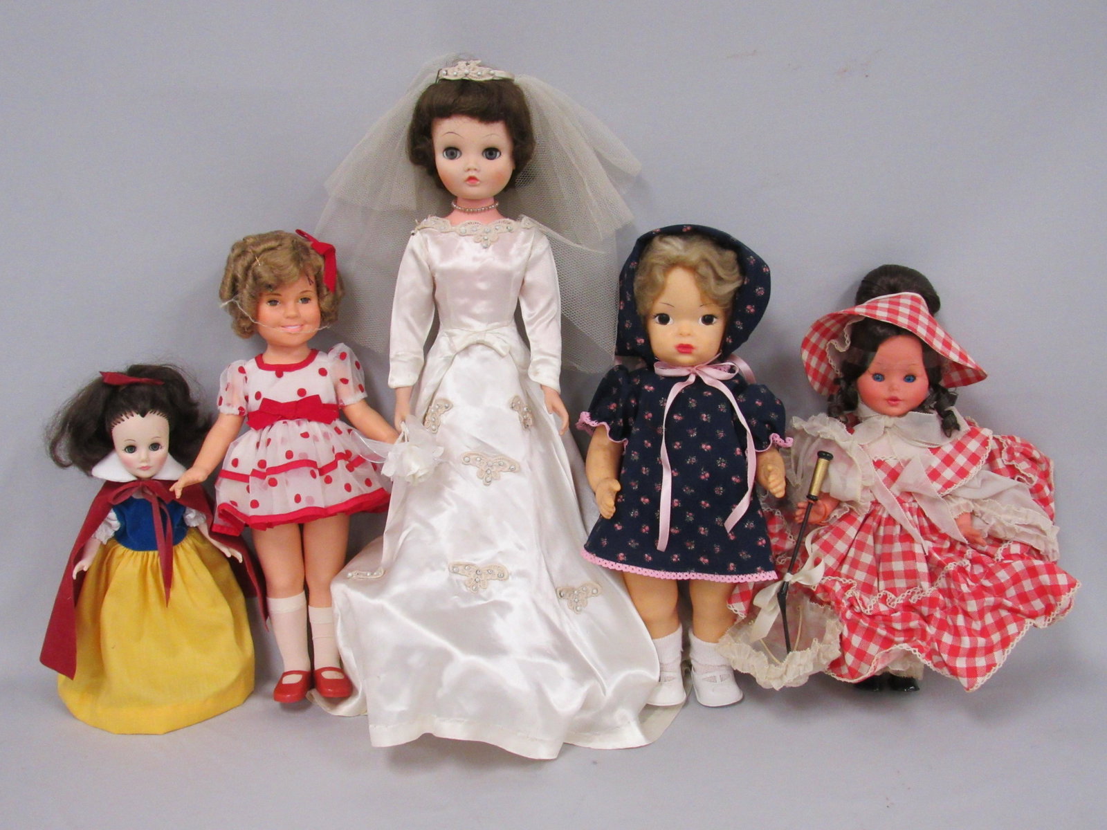5 DOLLS FROM 1950'S TO THE 1970'S:: 16 IN. TERRY LEE HP 1950'S - LIPS RETOUCHED. 25 IN. BONNIE BRIDE, 1960 THROWS BOUQUET. 16 IN. SHIRLEY TEMPLE - 1970'S, 1960'S FURGA ITALIAN DOLL & EFFANBEE SNOW WHITE - LATER 1970'S. ALL DISPLAYED OR