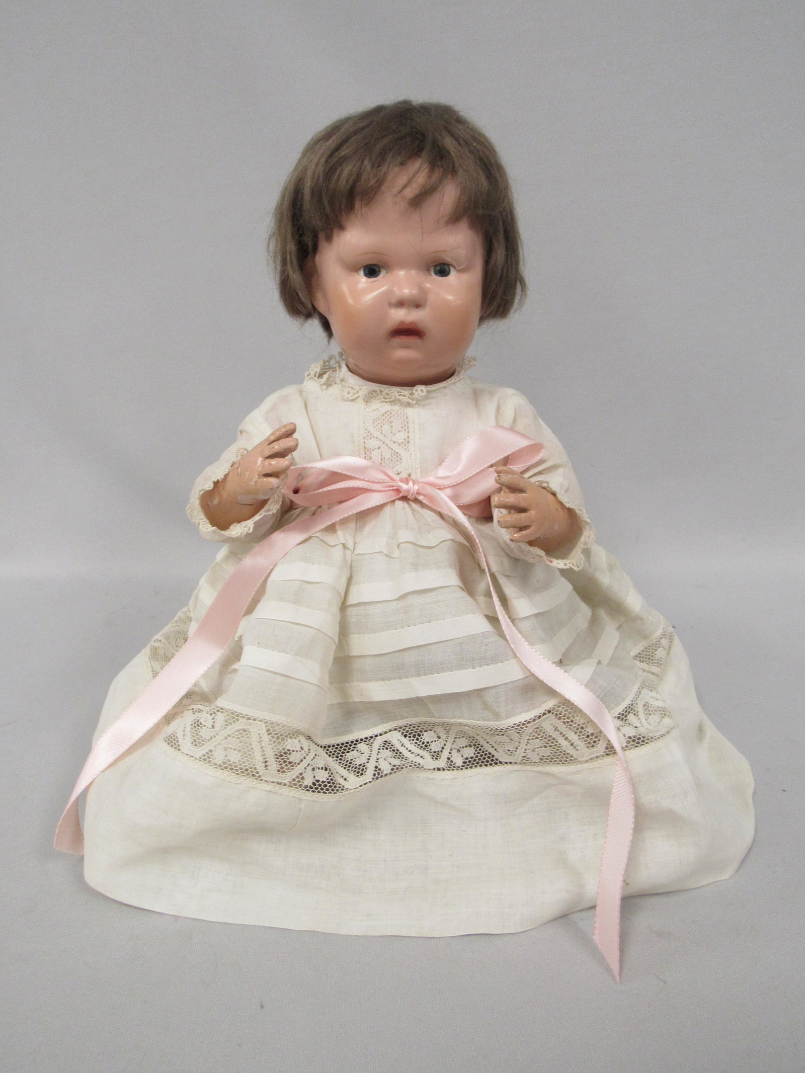 SCHOENHUT BABY, ALL WOOD 14 IN.:: STAMPED ON BACK OF HEAD SCHOENHUT WITH A C IN A CIRCLE 1913-1930. BODY CLEAN WITH SOME WEAR. ORIGINAL WIG. WEAR TO BOTH HANDS FIRE CRACK ON FOREHEAD & PAINT FLAKE OVER LEFT EYE, ALL JOINTS WORK WELL -