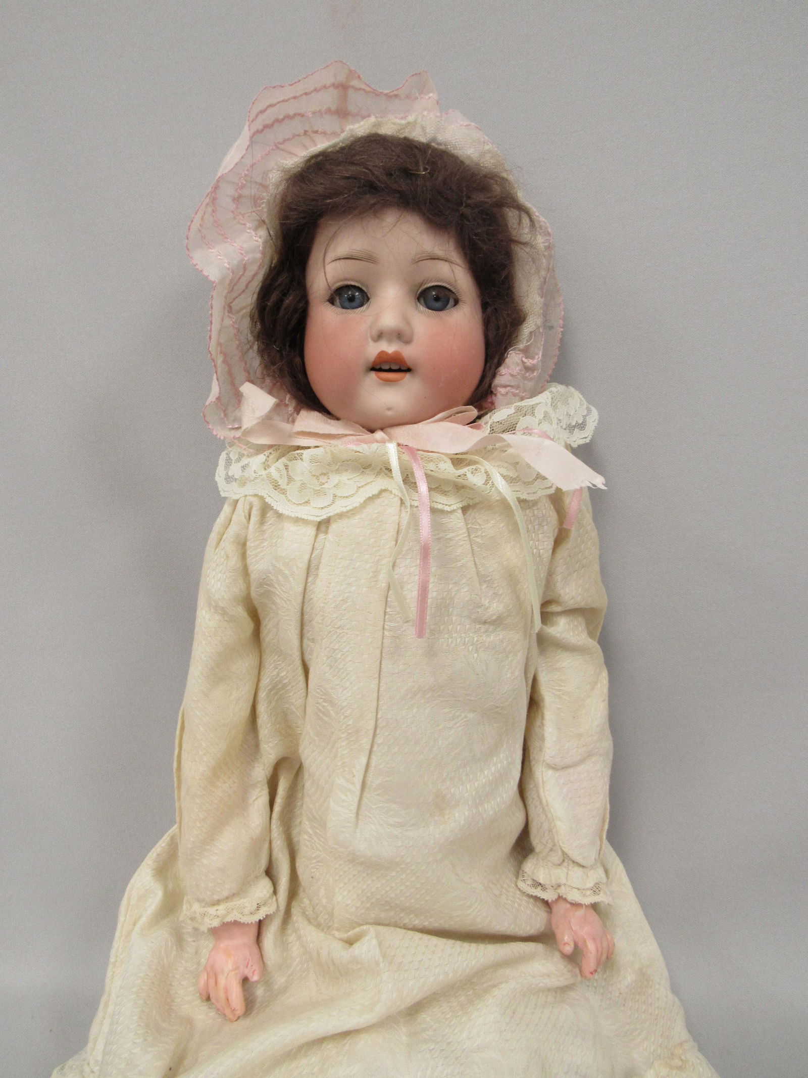 HEUBACH GERMANY GIRL 24 IN.:: BISQUE SHOULDER HEAD, OIL CLOTH JOINTED BODY. JOINTS AT ELBOW WITH COMPO ARMS - HIPS & KNEES, SOME LASH LOSS ON RIGHT EYELID, SLEEP EYES, 2 FLAKES ON TOP AREA OF CROWN, SEE PHOTOS - GOOD