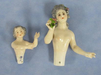 (2) CHINA HALF DOLLS:: 3 IN. ARMS AWAY IN FRONT OF BODY, DRESSEL OR KISTER. 4 1/2 IN. ARMS AWAY HOLDING FLOWER, PINKY CHIPPED ON LEFT HAND - GOOD