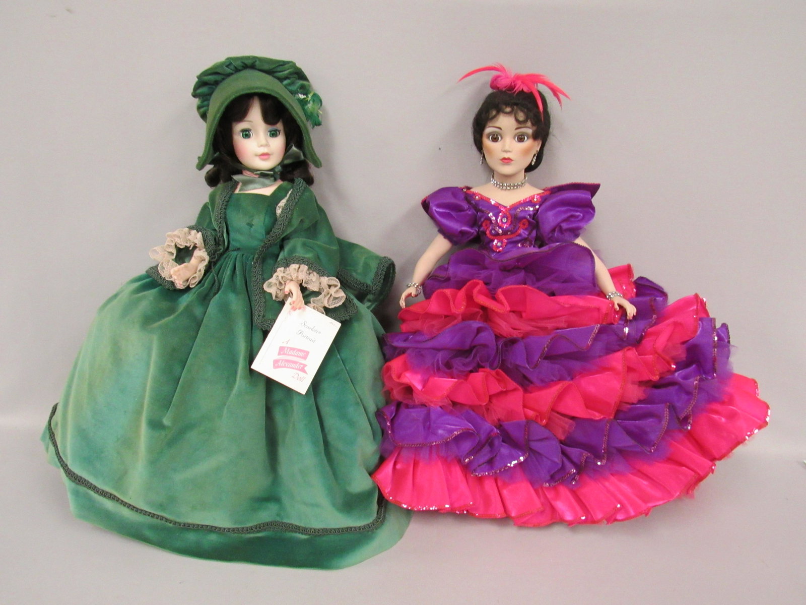 2 MADAME ALEXANDER PORTRAITS:: SCARLETT IN GREEN DRESS, SOME FADING THROUGHOUT. PORCELAIN "CARNIVAL IN RIO" SOME RUFFLES FLATTENED BECAUSE OF PACKING - GOOD