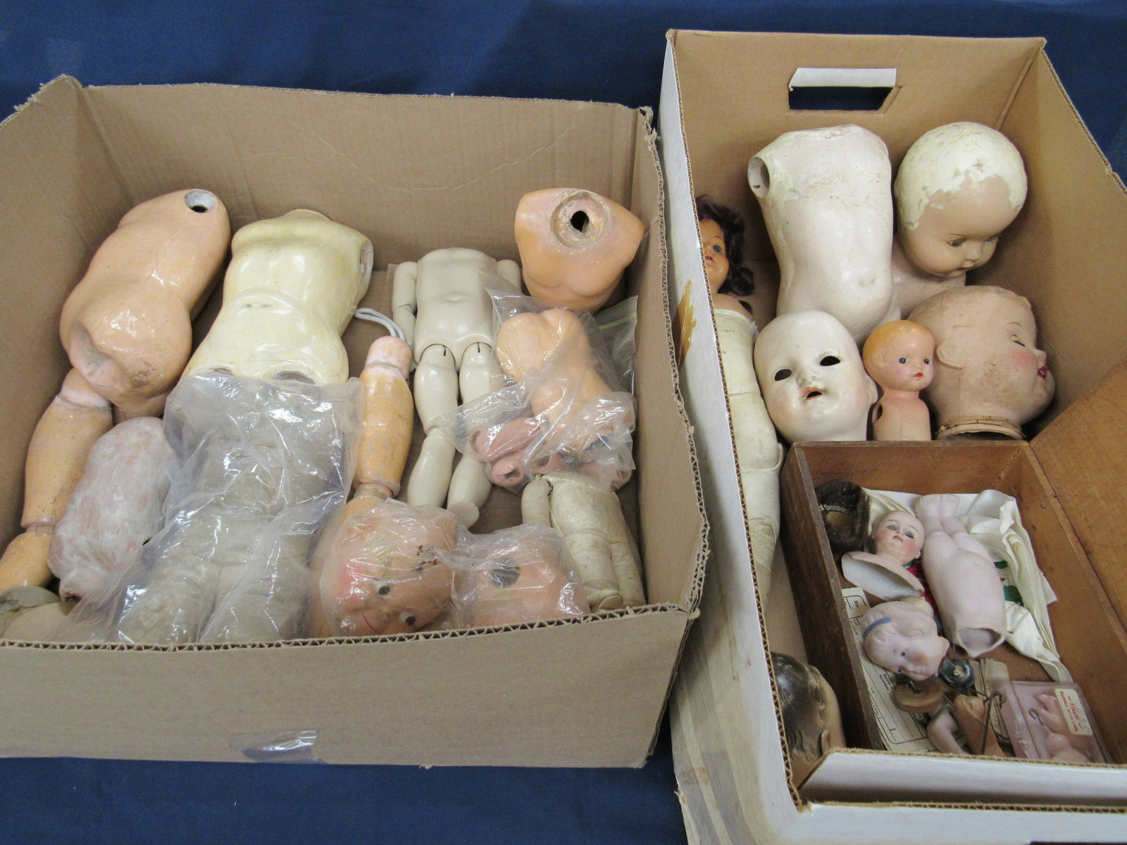 4 BOXES OF ANTIQUE COMPO BODY PARTS:: INCLUDES TORSOS, ARMS, LEGS, BALL JOINTS, SOME FINGERS, ETC., CONDITIONS VARY - AS FOUND TO VG - CHECK