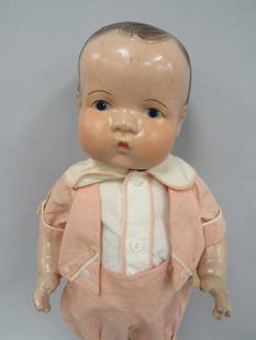 18 IN. UNMARKED COMPO BOY:: COMPOSITION HAS NORMAL PLAY WEAR & VERY SLIGHT CRAZING. THERE IS A SMALL CHIP ON CHEST. HIS FACE WAS TOUCHED UP. HE IS WEARING A GREAT OUTFIT