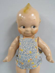 12 IN. COMPO "KEWPIE" BY CAMEO DOLL CO.:: VERY SLIGHT CRAZING. SMALL POCK MARKS ON LEFT LEG & TORSO. SUN SUIT IS MADE OF PERIOD CLOTH