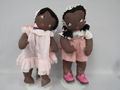 PAIR OF 21 IN. BLACK CLOTH DOLLS:: FROM THE SAME PATTERN. POSSIBLY FROM NEWSPAPER OR MAGAZINE. VERY FLOPPY. GIRL WITH BOOTS HAS HER HEAD SAFETY PINNED TO HER NECK. BOTH HAVE LIGHT STAINS ON BODIES