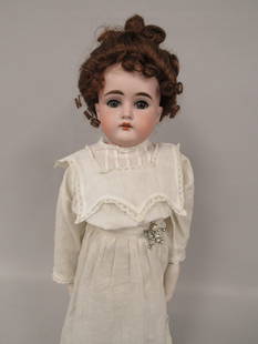 21 IN. EDMUND ULRICH STEINER:: BISQUE SHOULDER HEAD WITH SLEEP EYES & OPEN MOUTH. NO DAMAGE TO HEAD. KID BODY IS JOINTED AT SHOULDERS, ELBOWS WITH BISQUE LOWER ARMS, HIP & KNEES. RIGHT LOWER ARM IS HELD BY RIVET ON ONE SIDE