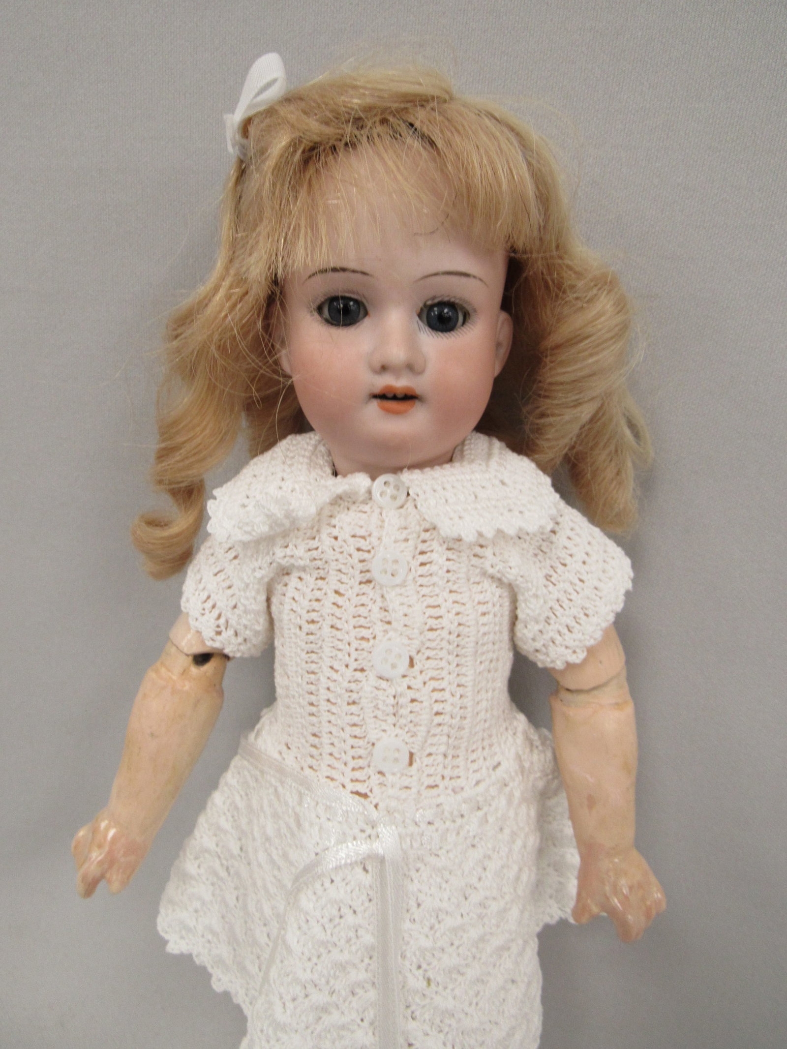 11 IN. ARMAND MARSEILLE MARKED MADE IN GERMANY:: ARMAND MARSEILLE 390 5/0M. BISQUE HEAD FREE OF ANY DAMAGE, SLEEP EYES, OPEN MOUTH WITH TEETH. COMPO BODY CLEAN WITH NORMAL WEAR. SHE HAS AN EXTRA DRESS MATERIAL