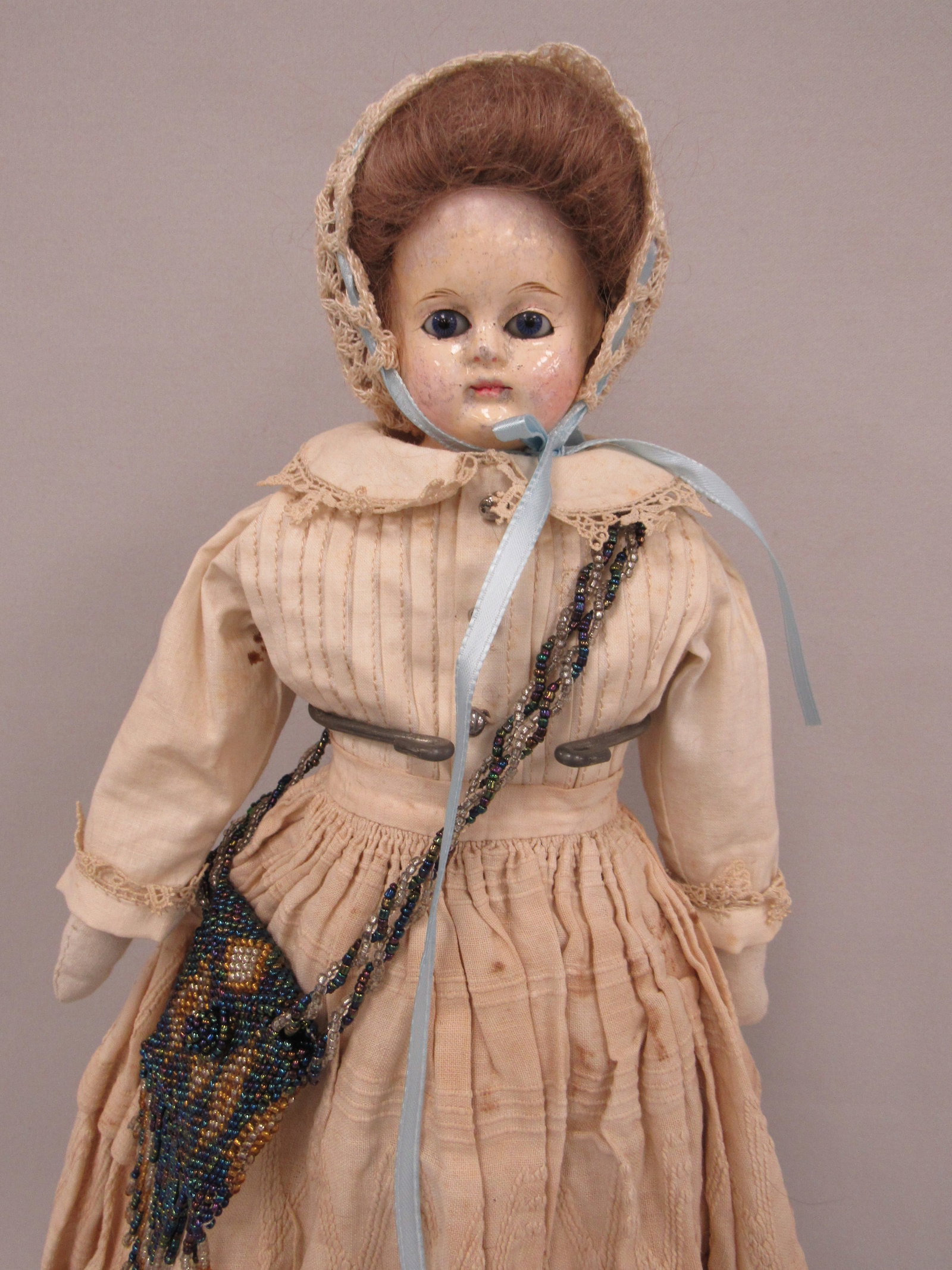 20 IN. PAPER MACHE WITH GLASS EYES:: HAS TOUCH-UPS ON CHEEKS & FOREHEAD, SHOULDERHEAD IS DAMAGE FREE ON NEWER CLOTH BODY. SHE HAS ORIGINAL SKIRT, HALF SLIP & PANTALOONS