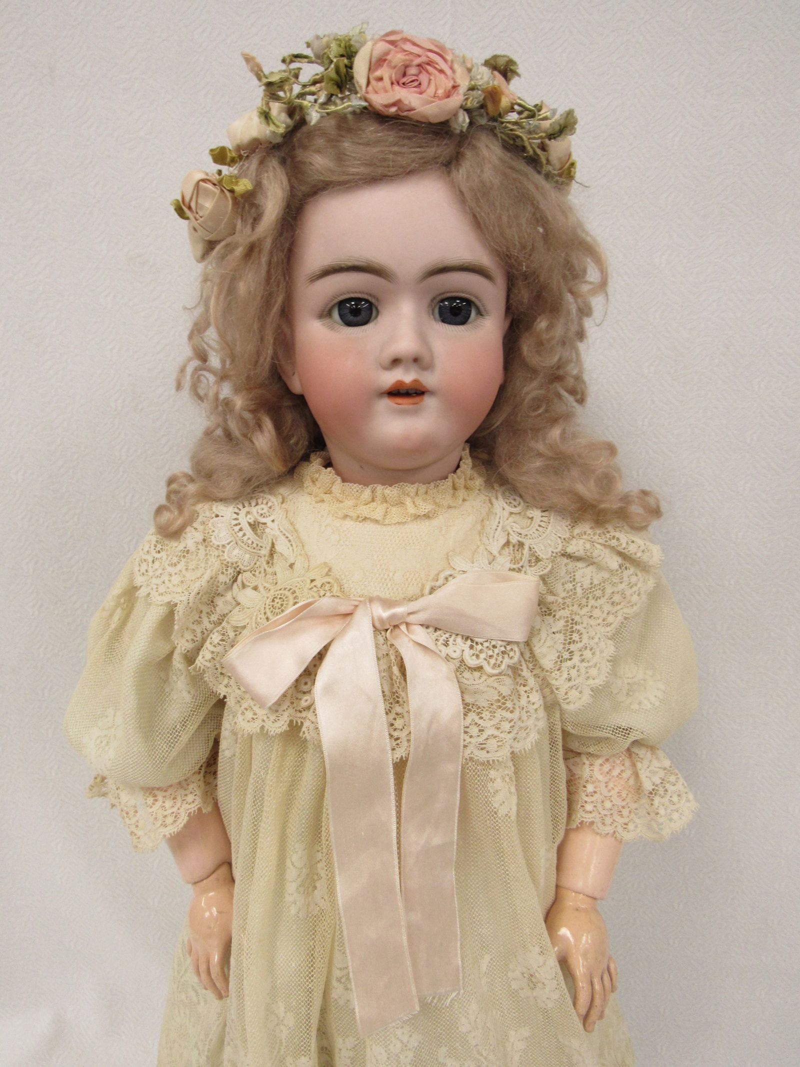 29 IN. EARLY MODEL HANDWERCK 99: BISQUE SOCKET HEAD INCISED 14.99. HANDWERCK GERMANY 5 1/2, BLUE GLASS SLEEPING EYES, OPEN MOUTH WITH FOUR PORCELAIN TEETH, PIERCED EARS, ON HER ORIGINAL FULLY JOINTED COMPOSITION BODY, VINTAGE LACE DR