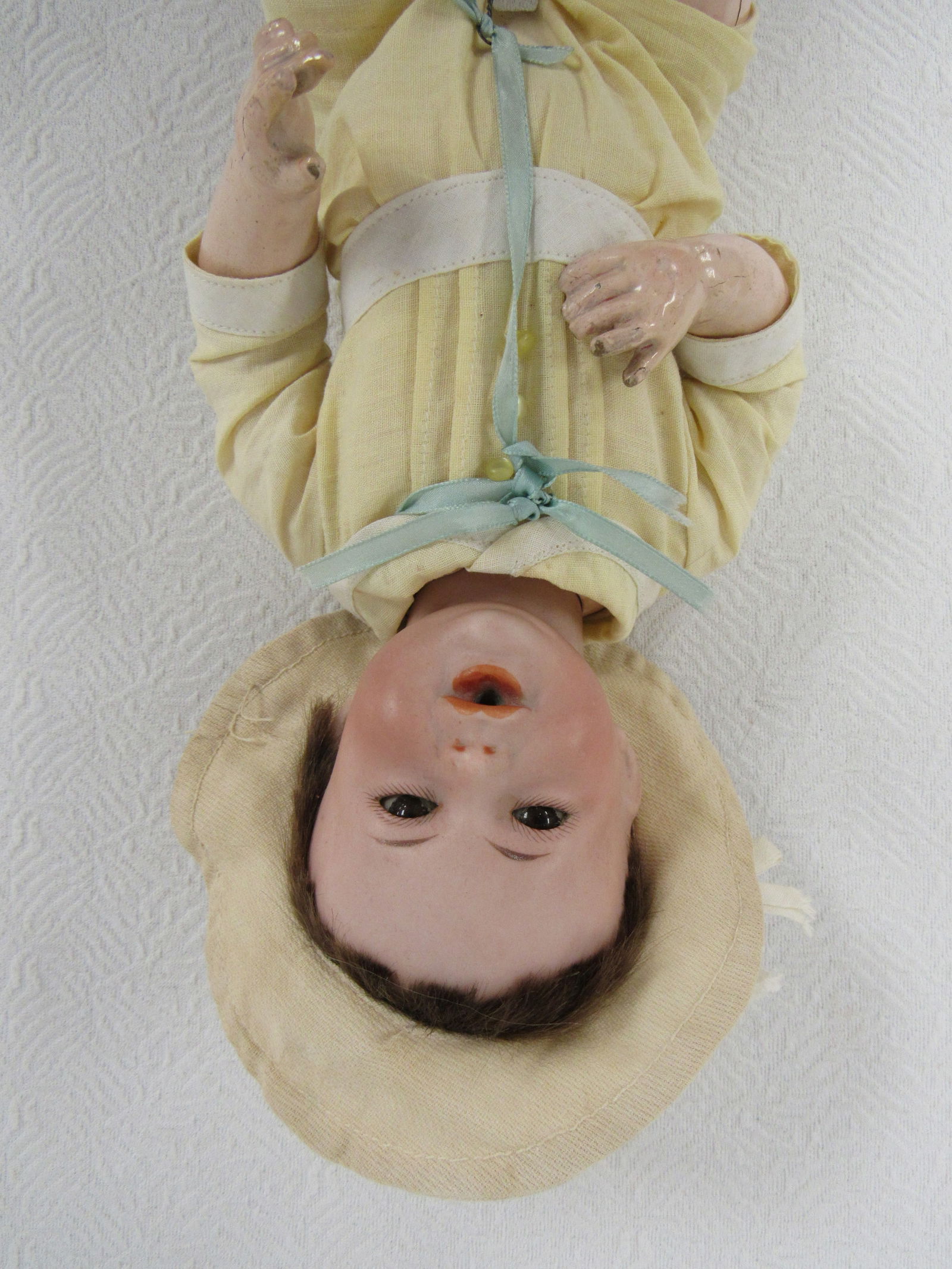 12 IN. ADORABLE S. F. B. J. 242 NURSING BABY:: BISQUE SOCKET HEAD INCISED SFBJ 242 PARIS, BROWN GLASS SQUINTING EYES, OPEN MOUTH WITH ROUND OPENING FOR NURSING BOTTLE, CORK PATE, UPPER FOREHEAD HAS TRACES OF MOLDED HAIR UNDER BROWN MOHAIR WIG. ORI