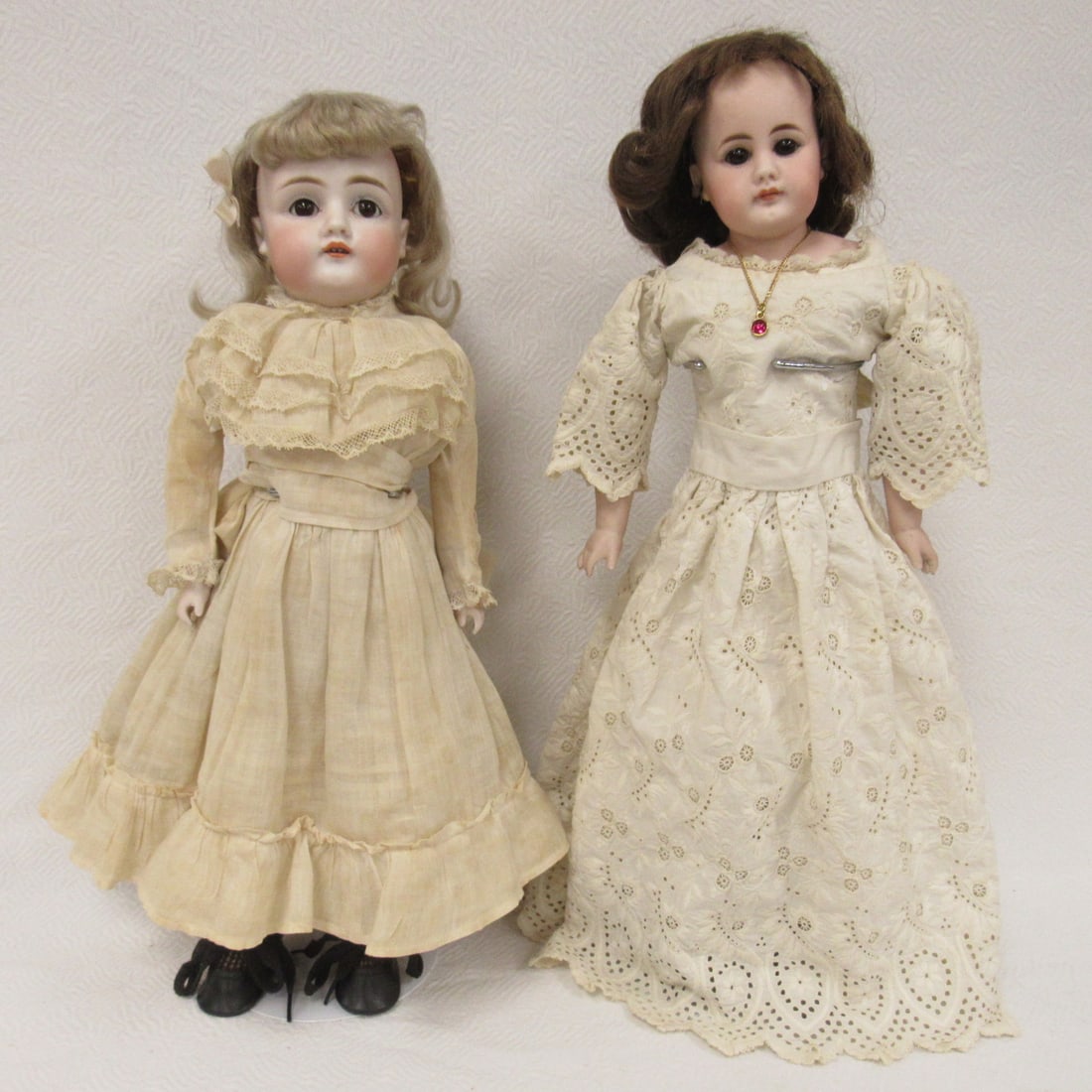 PAIR OF GERMAN BISQUE DOLLS:: 17 IN. D.E.P. 7 154 BY KESTNER, BISQUE SHOULDER PLATE DAMAGE FREE, SLEEP EYES ARE SET, OPEN MOUTH WITH TEETH, FIRM KID BODY WITH BISQUE LOWER ARMS. 19 IN. SIMON HALBIG. MARKED S 7 H 950, SOLID DOME, C