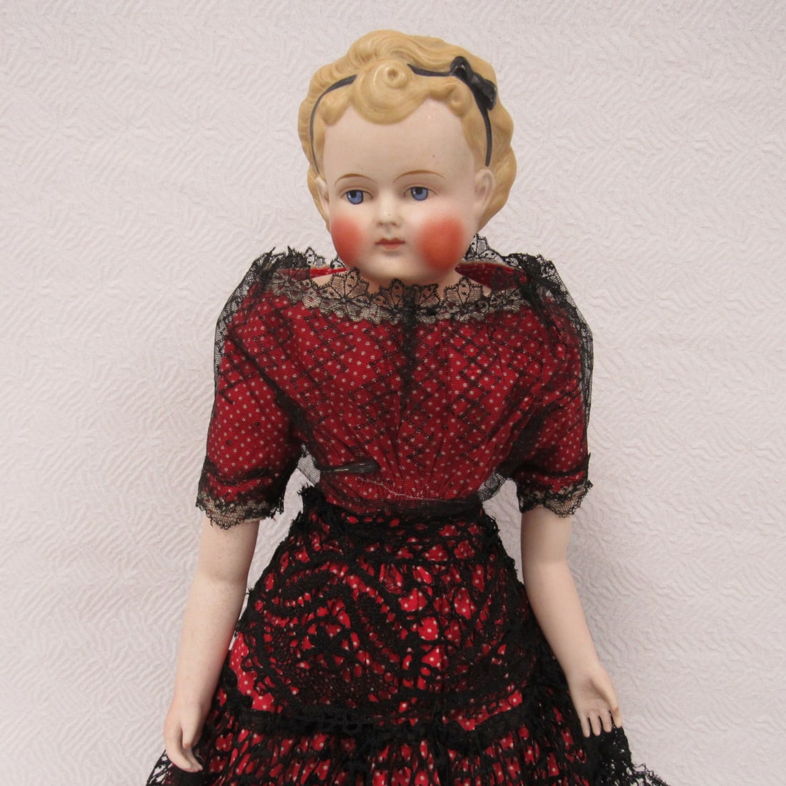 16 IN. PARIAN SIDE GLANCING SHOULDER HEAD:: NO DAMAGE TO HEAD OR MARKS. BISQUE ARMS, OLD CLOTH BODY. OLD OIL CLOTH BOOTS ARE CRACKING ESPECIALLY THE RIGHT ONE. DRESS HAS SOME TEARS ON THE LEFT SIDE