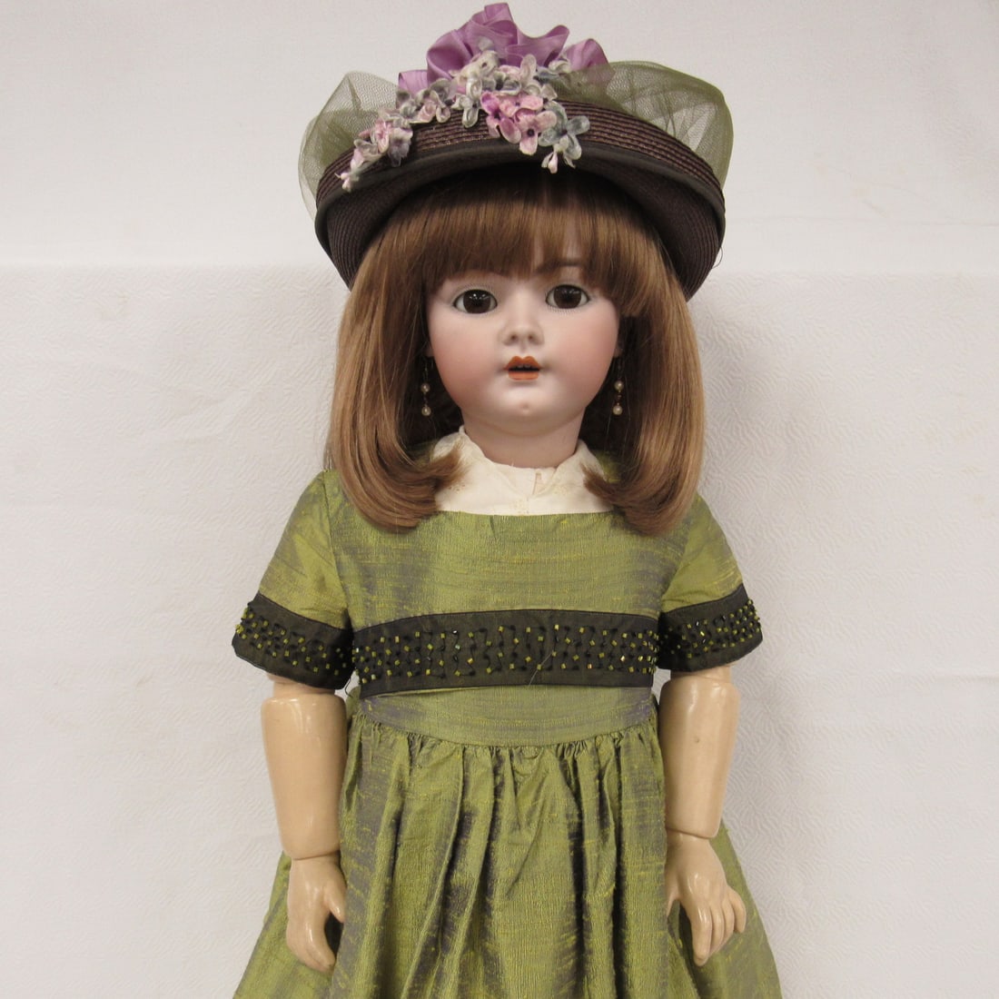 33 1/2 IN. HANDWERK MARKED 16 1/2 HANDWERK 7 1/2:: BISQUE SOCKET HEAD NO DAMAGE, SLEEP EYES, OPEN MOUTH WITH TEETH, LARGE STURDY JOINTED COMPO BODY (REPAINTED). BEAUTIFUL SILK DRESS