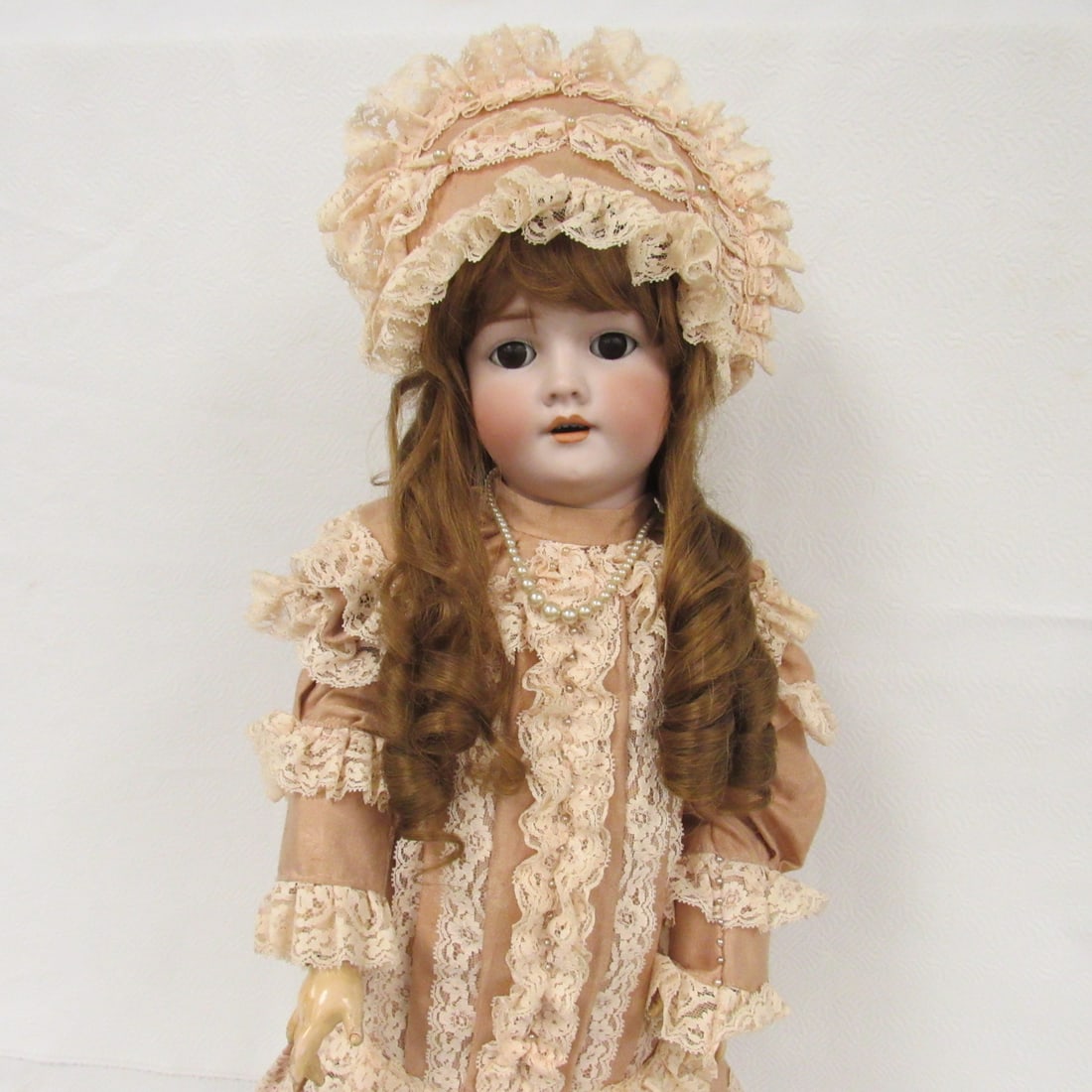 27 IN. HANDWERCK MARKED 109-15 DEP GERMANY:: BISQUE SOCKET HEAD NO DAMAGE, SLEEP EYES, OPEN MOUTH WITH TEETH, PIERCED EARS. CLEAN STURDY BODY WITH NORMAL WEAR, SOME PAINT CHIPPING AT HIP JOINTS. SHE HAS TWO HATS